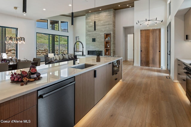 15374 S Chalone Dr, Coeur Dalene, ID 83814 - kitchen with dishwashing machine, open floor plan, a high ceiling, light wood-style flooring, and modern cabinets