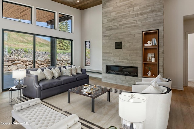 15374 S Chalone Dr, Coeur Dalene, ID 83814 - living room with a towering ceiling, wood finished floors, a tiled fireplace, and wooden ceiling
