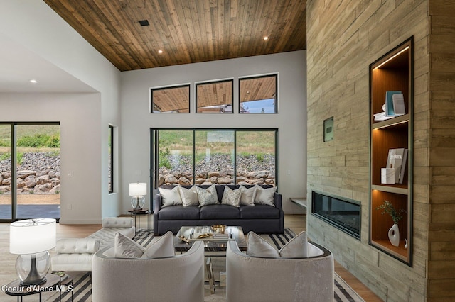 15374 S Chalone Dr, Coeur Dalene, ID 83814 - living room featuring wood finished floors, a high ceiling, a tiled fireplace, wood ceiling, and recessed lighting