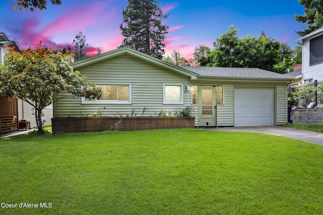 view of front of house with a lawn and a garage