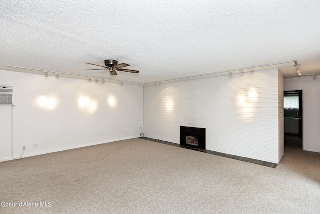 unfurnished living room featuring brick wall, carpet floors, a fireplace, and ceiling fan