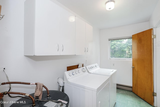 clothes washing area featuring cabinets and washer and dryer