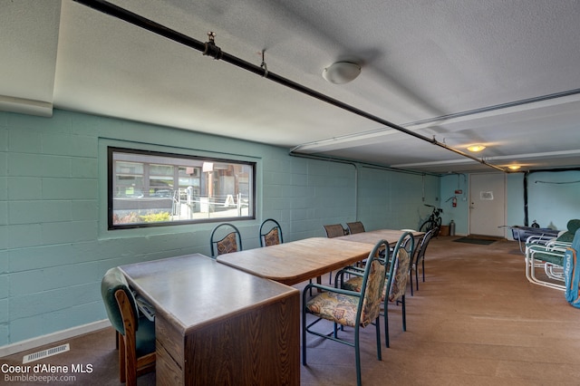 dining area featuring a textured ceiling