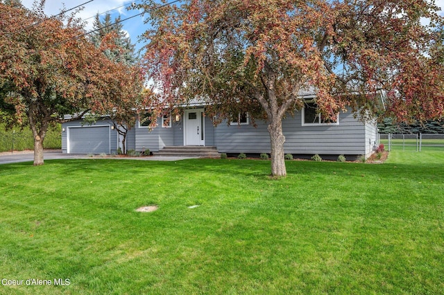 view of property hidden behind natural elements with a garage and a front lawn