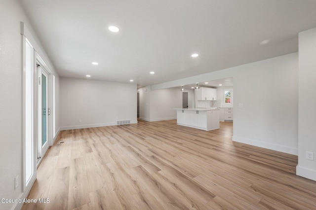 unfurnished living room featuring light wood-type flooring