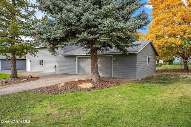 exterior space featuring a lawn and a garage