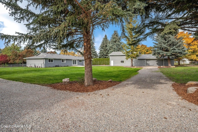 ranch-style home featuring a front yard and a garage