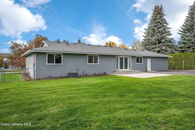 rear view of property featuring a patio area, a lawn, and cooling unit