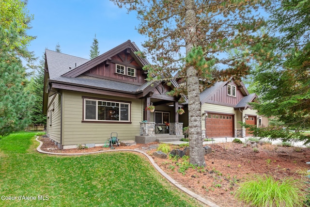 craftsman inspired home with a garage, a front yard, and covered porch