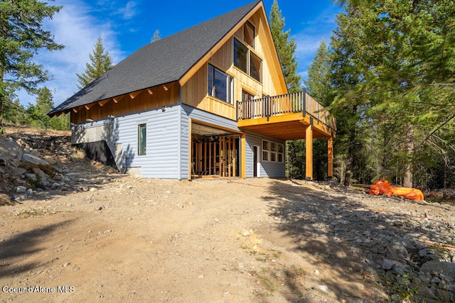 view of side of home featuring a wooden deck