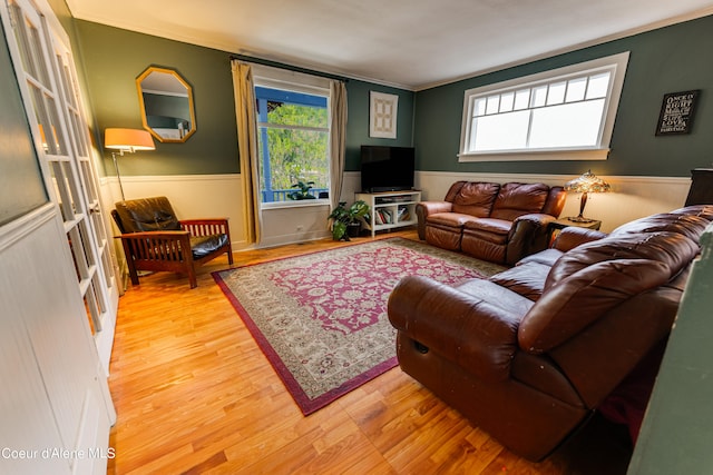 living room featuring crown molding and hardwood / wood-style flooring