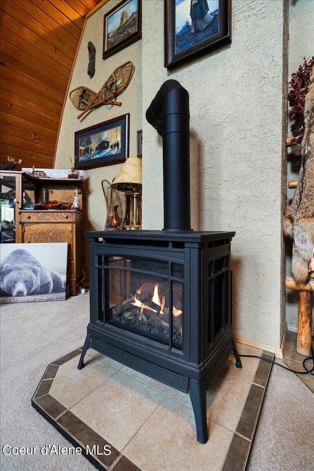 details featuring wooden ceiling and a wood stove