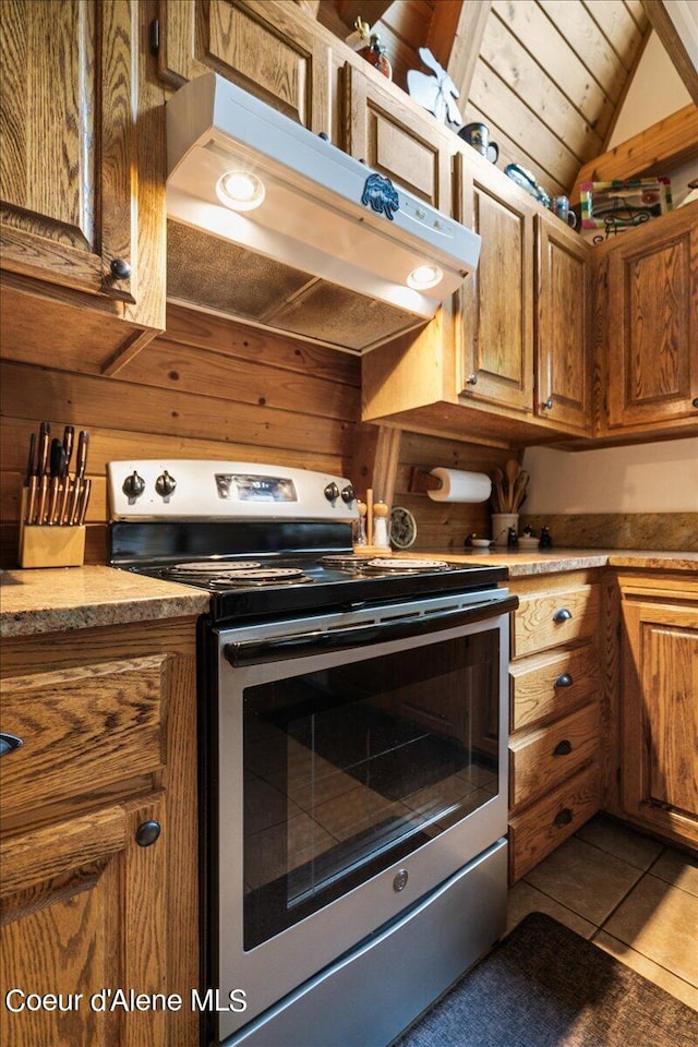 kitchen featuring lofted ceiling, wood ceiling, range hood, light tile patterned flooring, and stainless steel electric range oven