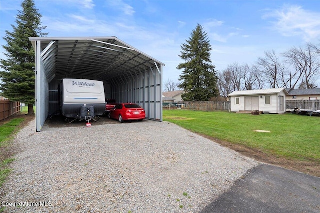 view of parking with a yard and a carport