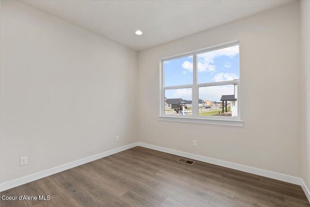 spare room with wood-type flooring