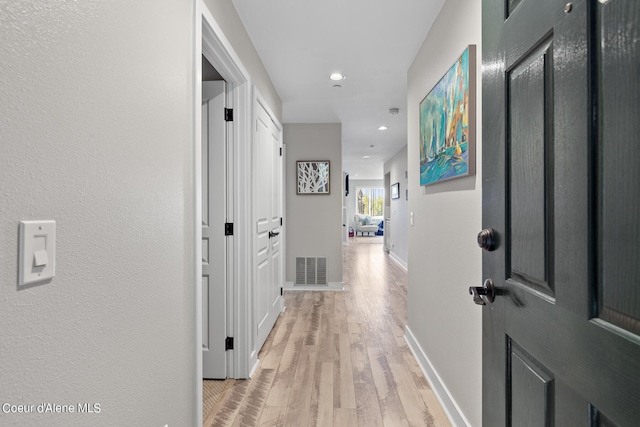 corridor with light wood-type flooring