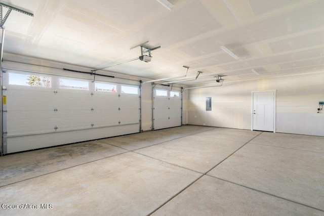 garage with electric panel and a garage door opener