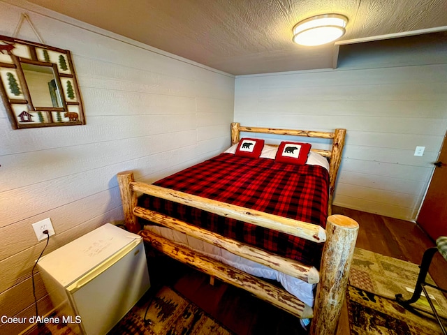 bedroom with dark wood-type flooring and a textured ceiling