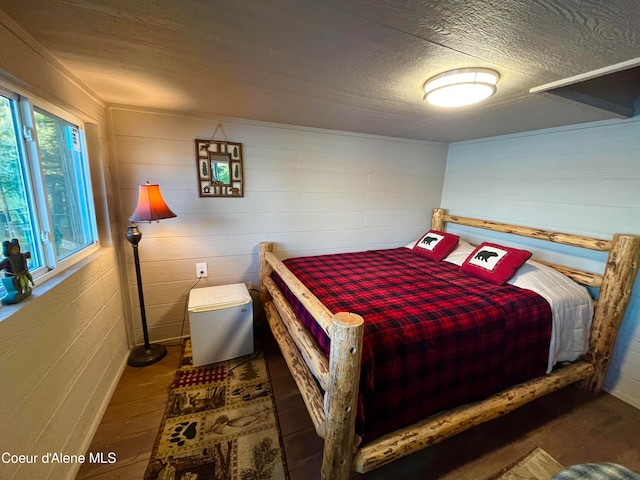 bedroom with dark hardwood / wood-style flooring