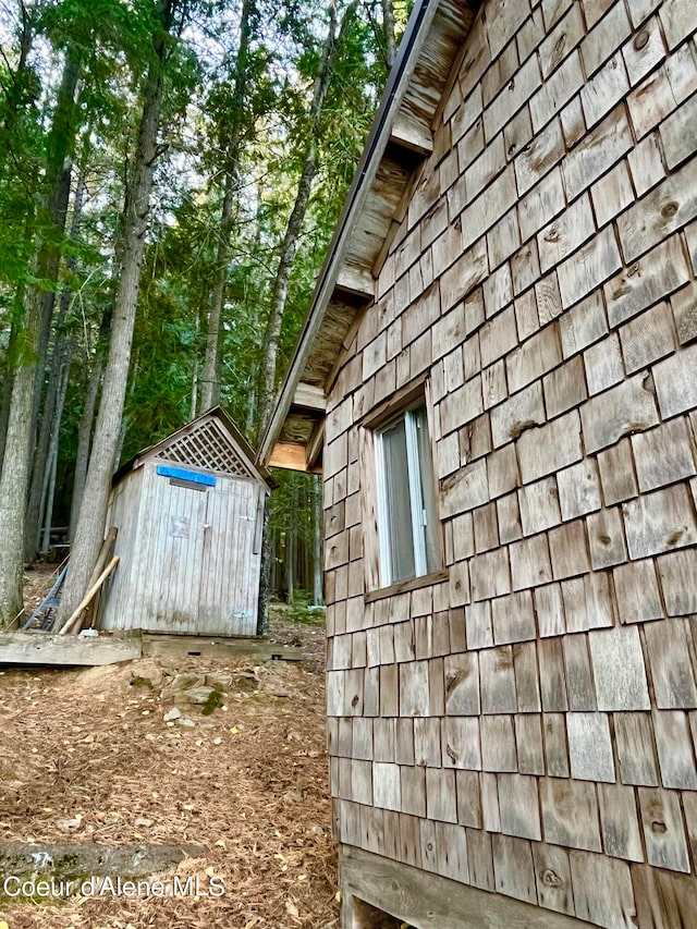 view of side of property with a shed