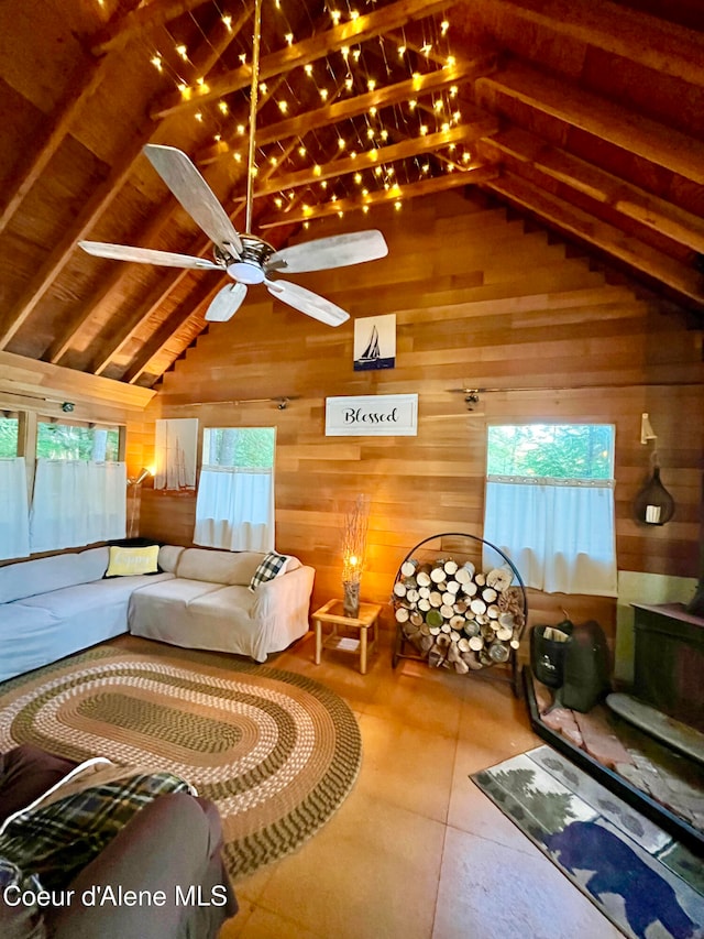 interior space with beam ceiling, high vaulted ceiling, and wooden walls