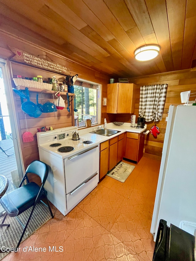 kitchen featuring white appliances, wood walls, sink, wood ceiling, and light tile patterned floors