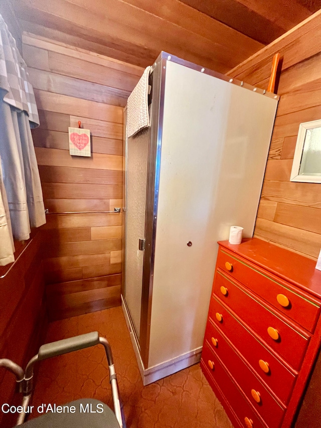 bathroom featuring wood walls and wooden ceiling