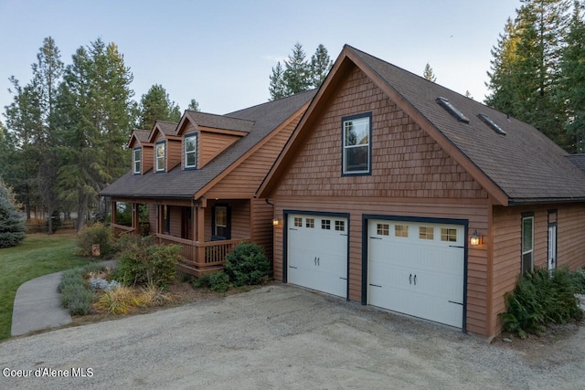 110 Sheri Dr, Moyie Springs, ID 83845 - view of front of house with a porch, a shingled roof, and an attached garage