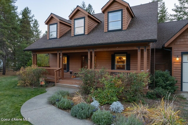 110 Sheri Dr, Moyie Springs, ID 83845 - view of front of house with a porch, a shingled roof, and a front yard
