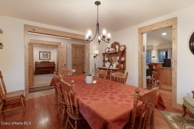 dining room featuring hardwood / wood-style floors and an inviting chandelier