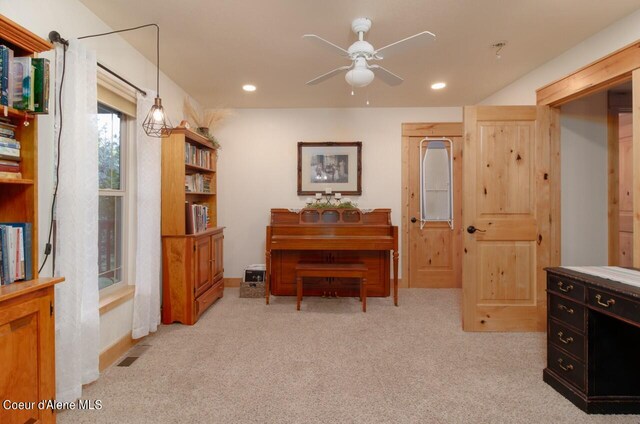 misc room featuring light colored carpet and ceiling fan