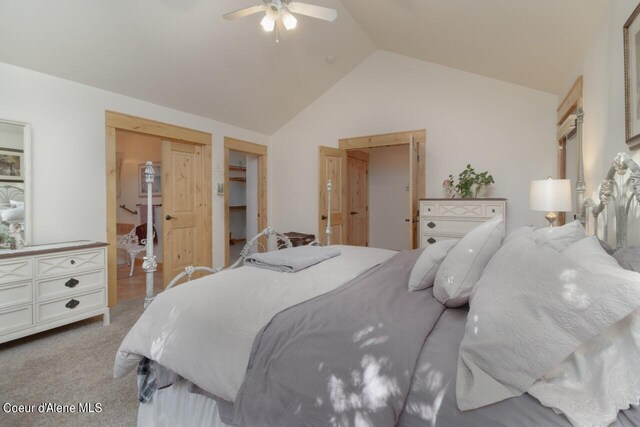 bedroom featuring ceiling fan, vaulted ceiling, and light colored carpet