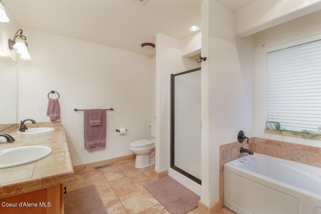 full bathroom with vanity, toilet, and independent shower and bath