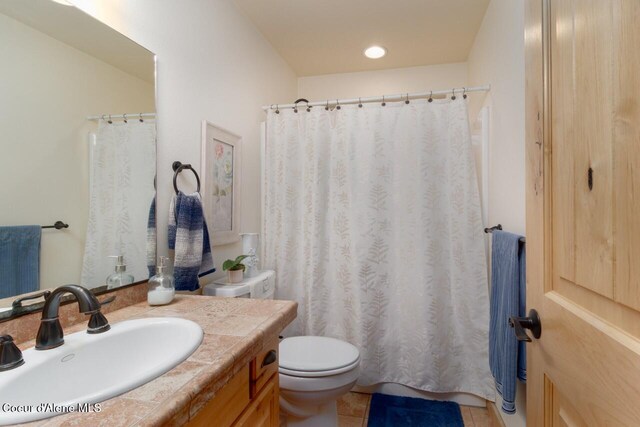 bathroom with vanity, toilet, and tile patterned floors