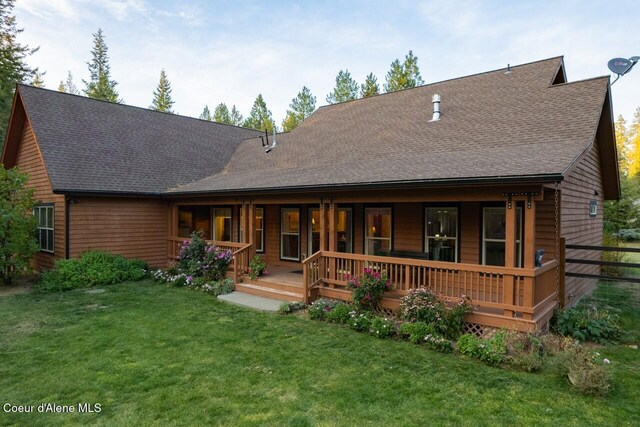 back of house with a yard and a porch