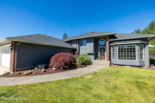 view of front of house with a front yard and a garage