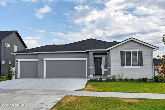 view of front of property featuring a front yard and a garage