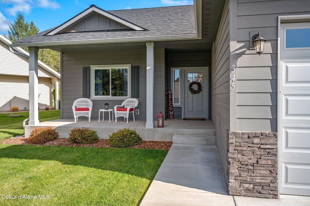 doorway to property with a lawn and a porch