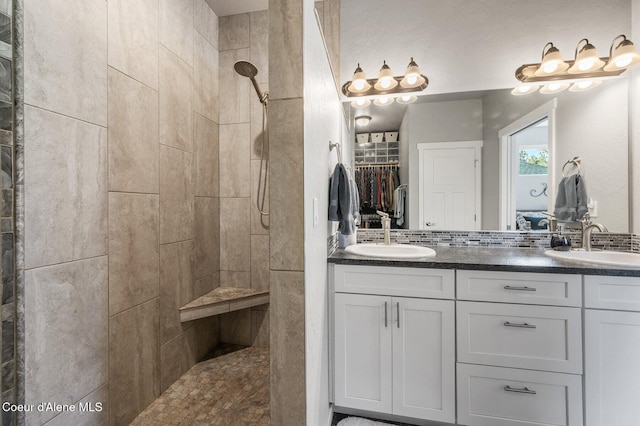 bathroom featuring vanity and a tile shower