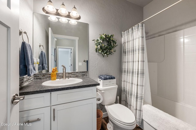 full bathroom with vanity, toilet, and shower / bath combo with shower curtain