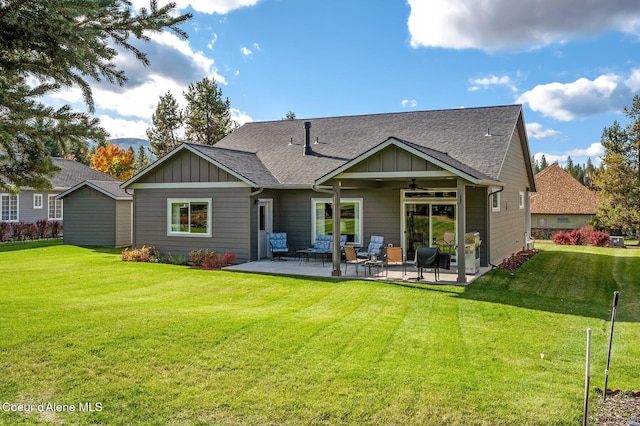 rear view of house featuring a yard, a patio, and ceiling fan