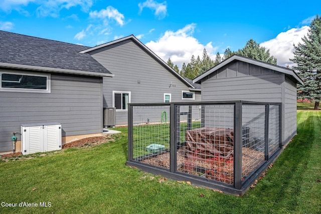 exterior space featuring a yard and an outbuilding