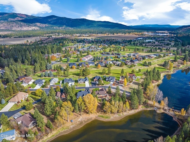 birds eye view of property with a water and mountain view