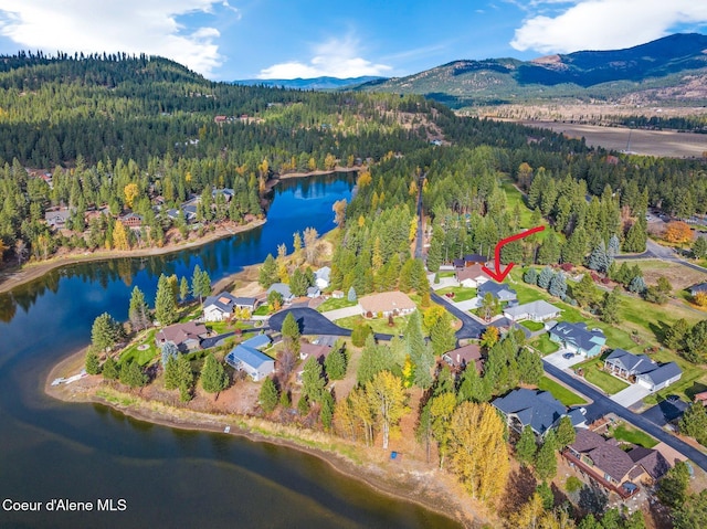 aerial view featuring a water and mountain view