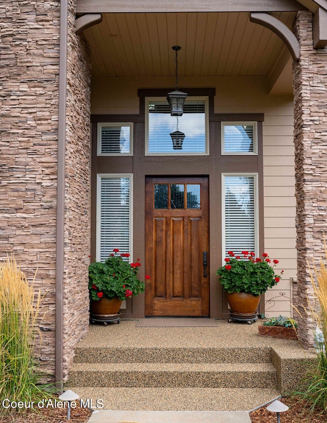 view of exterior entry featuring covered porch