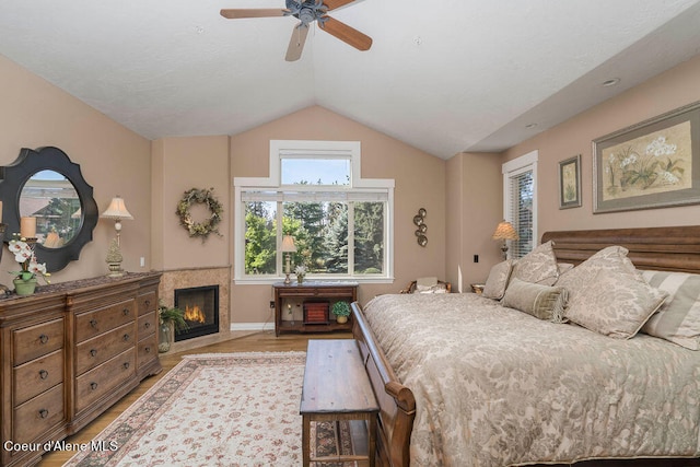 bedroom featuring light hardwood / wood-style flooring, ceiling fan, and vaulted ceiling