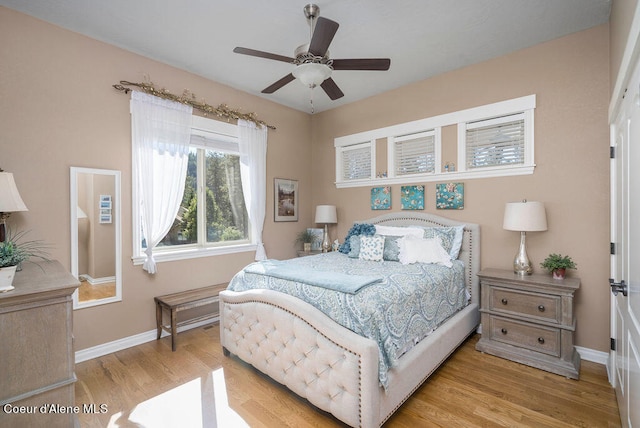 bedroom with ceiling fan and light hardwood / wood-style floors