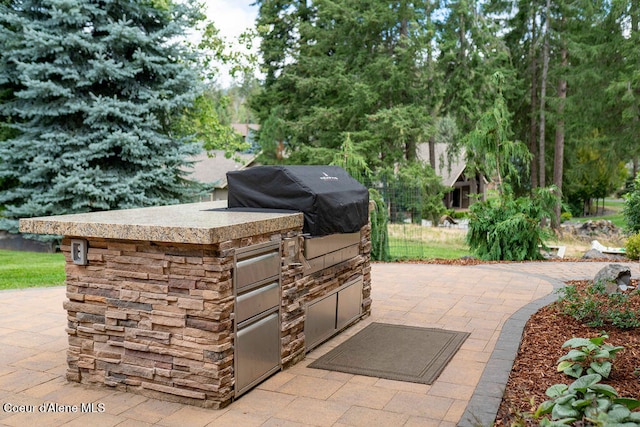 view of patio / terrace featuring grilling area and an outdoor kitchen