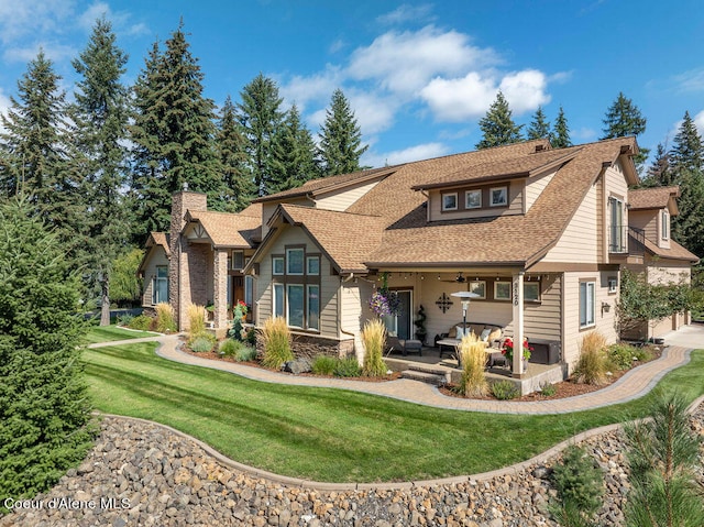 back of house featuring a lawn and ceiling fan