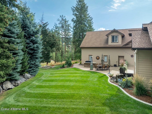 rear view of property featuring a patio and a yard